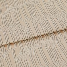 A folded piece of fabric with Maud Shell Brown printed on it