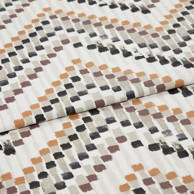 A folded piece of fabric with Holi Desert Orange printed on it