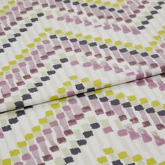 A folded piece of fabric with Holi Orchid Purple printed on it
