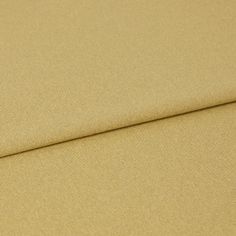 A folded piece of fabric with Huxley Honey Yellow printed on it