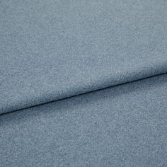 A folded piece of fabric with Huxley Steel Blue printed on it