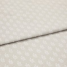 A folded piece of fabric with Layla Stone Cream printed on it