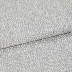 A folded piece of fabric with Maxwell Lunar Silver printed on it