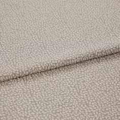 A folded piece of fabric with Maxwell Mink Cream printed on it