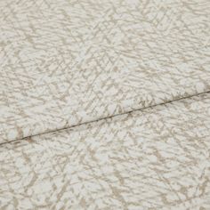 A folded piece of fabric with Morse Natural Cream printed on it
