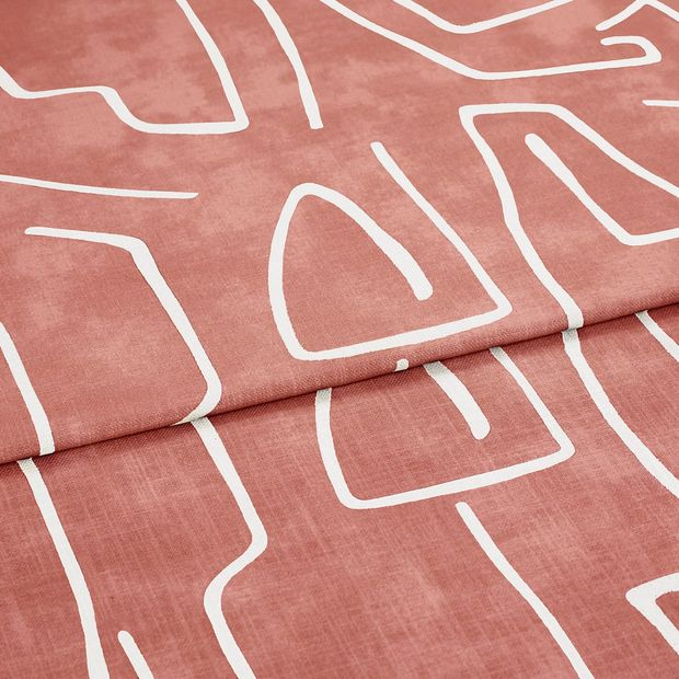A folded piece of fabric with Nora Bruschetta Red printed on it