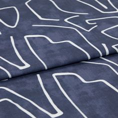 A folded piece of fabric with Nora Indigo Blue printed on it