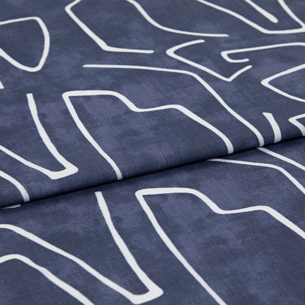 A folded piece of fabric with Nora Indigo Blue printed on it