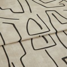 A folded piece of fabric with Nora Putty Cream printed on it