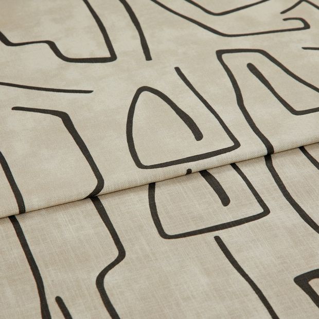 A folded piece of fabric with Nora Putty Cream printed on it