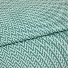 A folded piece of fabric with Pippa Aqua Light Green printed on it