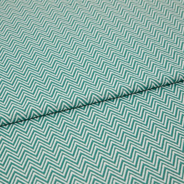 A folded piece of fabric with Pippa Aqua Light Green printed on it