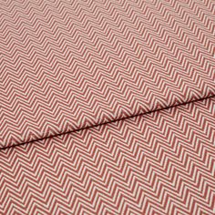 A folded piece of fabric with Pippa Coral Red printed on it