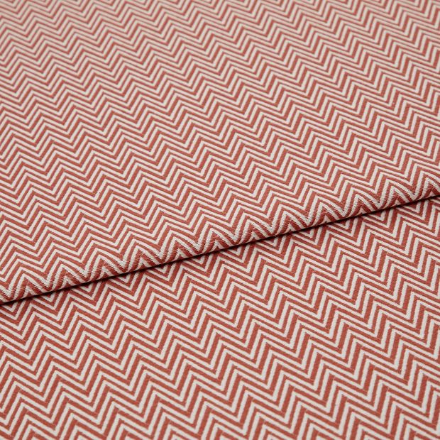 A folded piece of fabric with Pippa Coral Red printed on it