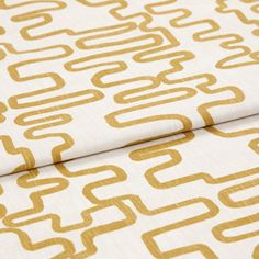 A folded piece of fabric with Wirl Chartreuse Yellow printed on it