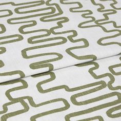 A folded piece of fabric with Wirl Kiwi Green printed on it