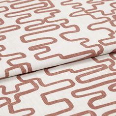 A folded piece of fabric with Wirl Sienna Orange printed on it