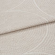 A folded piece of fabric with Zane Almond Cream printed on it