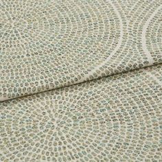 A folded piece of fabric with Zane Aspen Light Green printed on it