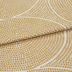A folded piece of fabric with Zane Sand Dune Gold printed on it