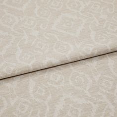 A folded piece of fabric with Prisha Linen Cream printed on it