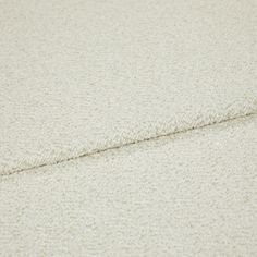 A folded piece of fabric with Soho Bouclé Ivory White printed on it