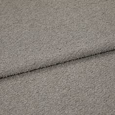 A folded piece of fabric with Soho Bouclé Silver printed on it