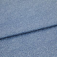 A folded piece of fabric with Spritz Cornflower Blue printed on it
