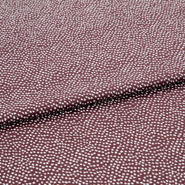A folded piece of fabric with Spritz Grape Purple printed on it