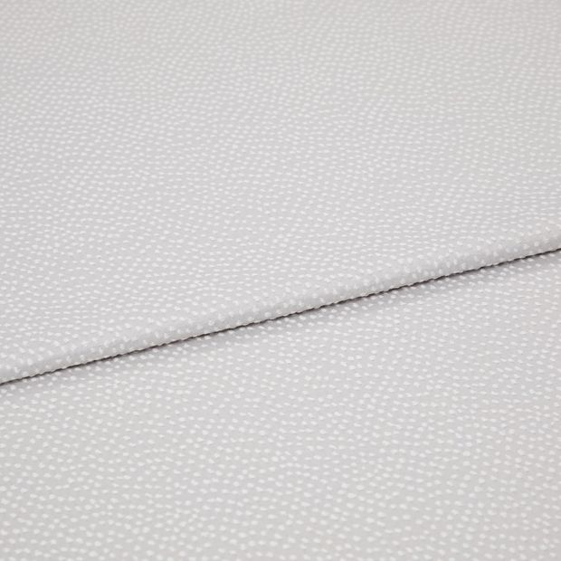 A folded piece of fabric with Spritz Marshmallow Silver printed on it