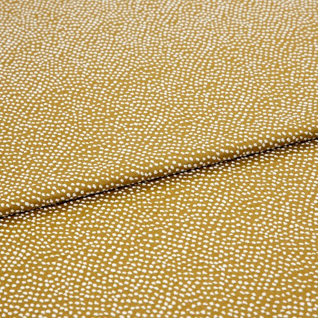 A folded piece of fabric with Spritz Mustard Gold printed on it