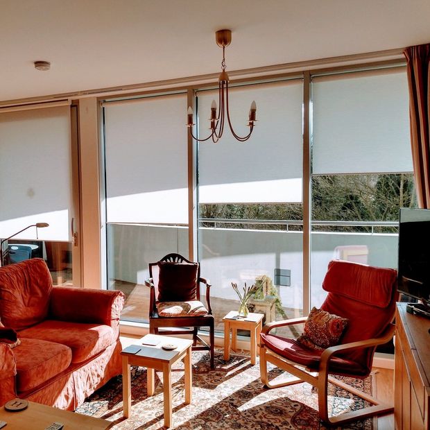 Cordova Ivory roller blind in cosy living room