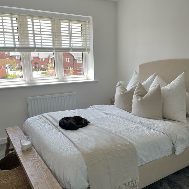 Illusions fine white faux wood venetian blinds half open in bedroom