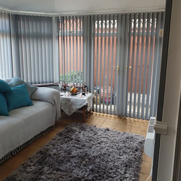 malin light grey floor length vertical blinds in conservatory