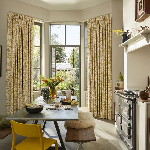 Wirl chartreuse yellow patterned curtains on bay window patio doors in kitchen/dining area