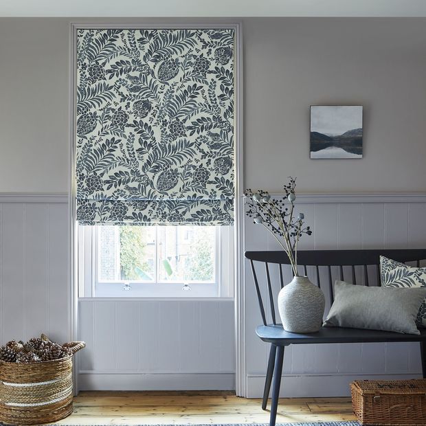Morris navy patterned roman blind in living space
