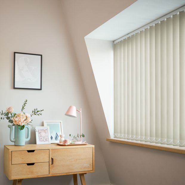 Cordova cream blackout vertical blinds in bedroom