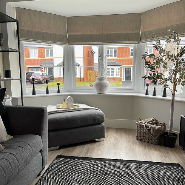 three arlington shingle roman blinds on bay window in living room