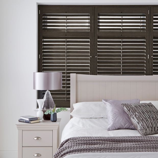 rustic black dalston wooden shutter on window above bed