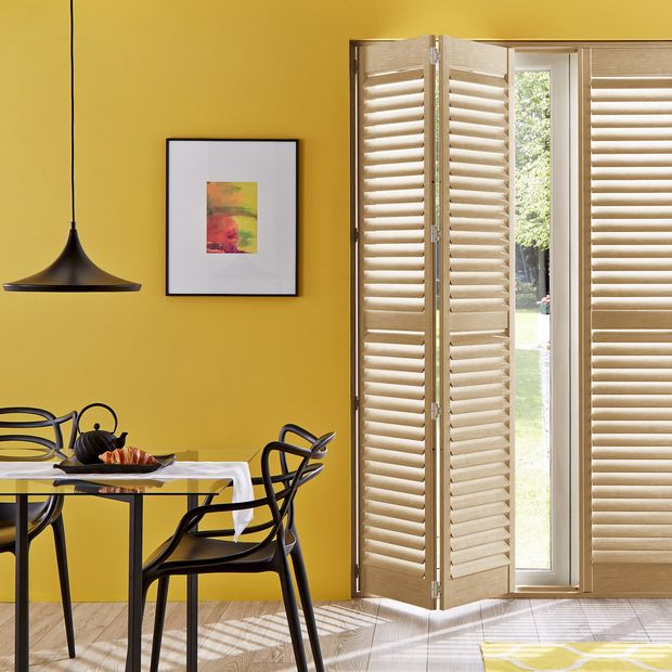 oak wooden tracked shutter on patio door to dining room