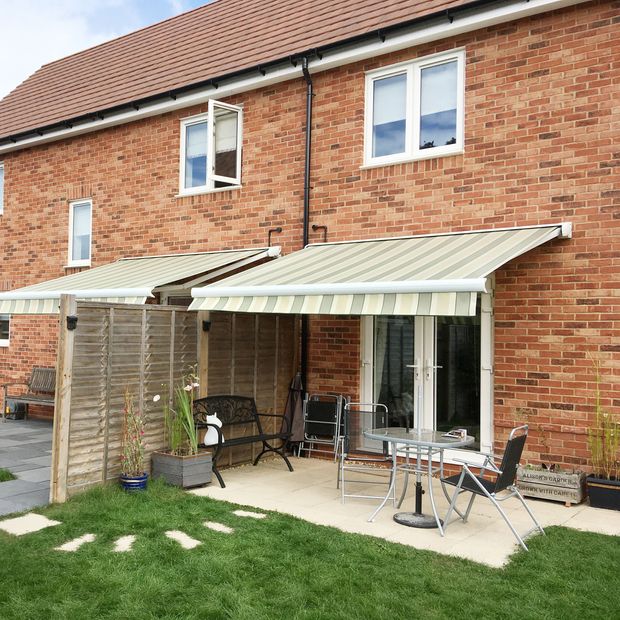 hardelot green striped awning over patio area leading to garden