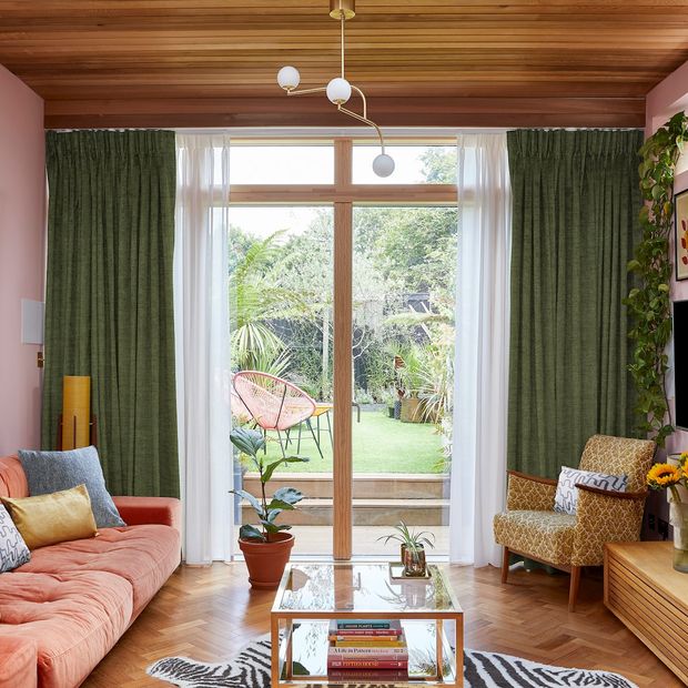 full height lindora pesto green curtains in an eclectically decorated living room