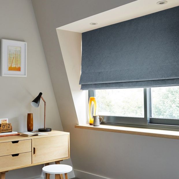 plain dark blue roman blind on wide window in minimalist bedroom