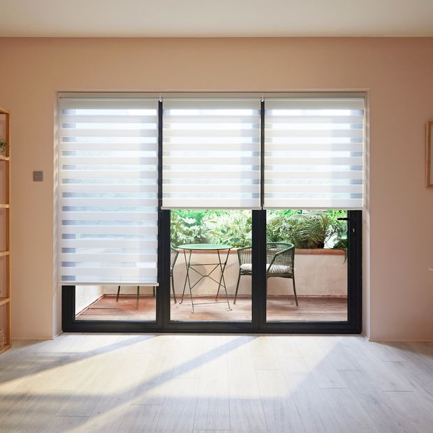 white day and night blinds on sliding patio doors in dining room area