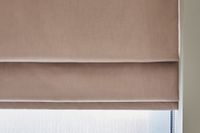 close up of light pink roman blind half closed