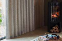 greige curtains covering large sliding patio doors with fire inside