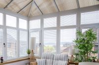 white metal venetian blinds on conservatory windows