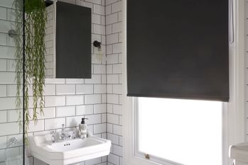 black roller blind in white traditional style monochrome bathroom