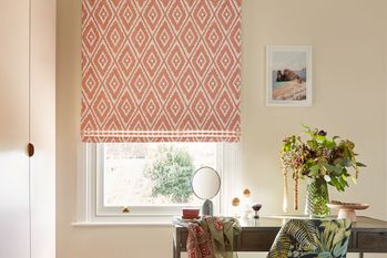 Mali coral orange blinds covering windows in a cream living room