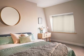 Cream vertical blinds shading a bedroom